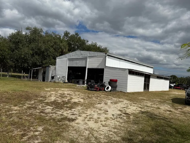 a view of a house with a yard and garage