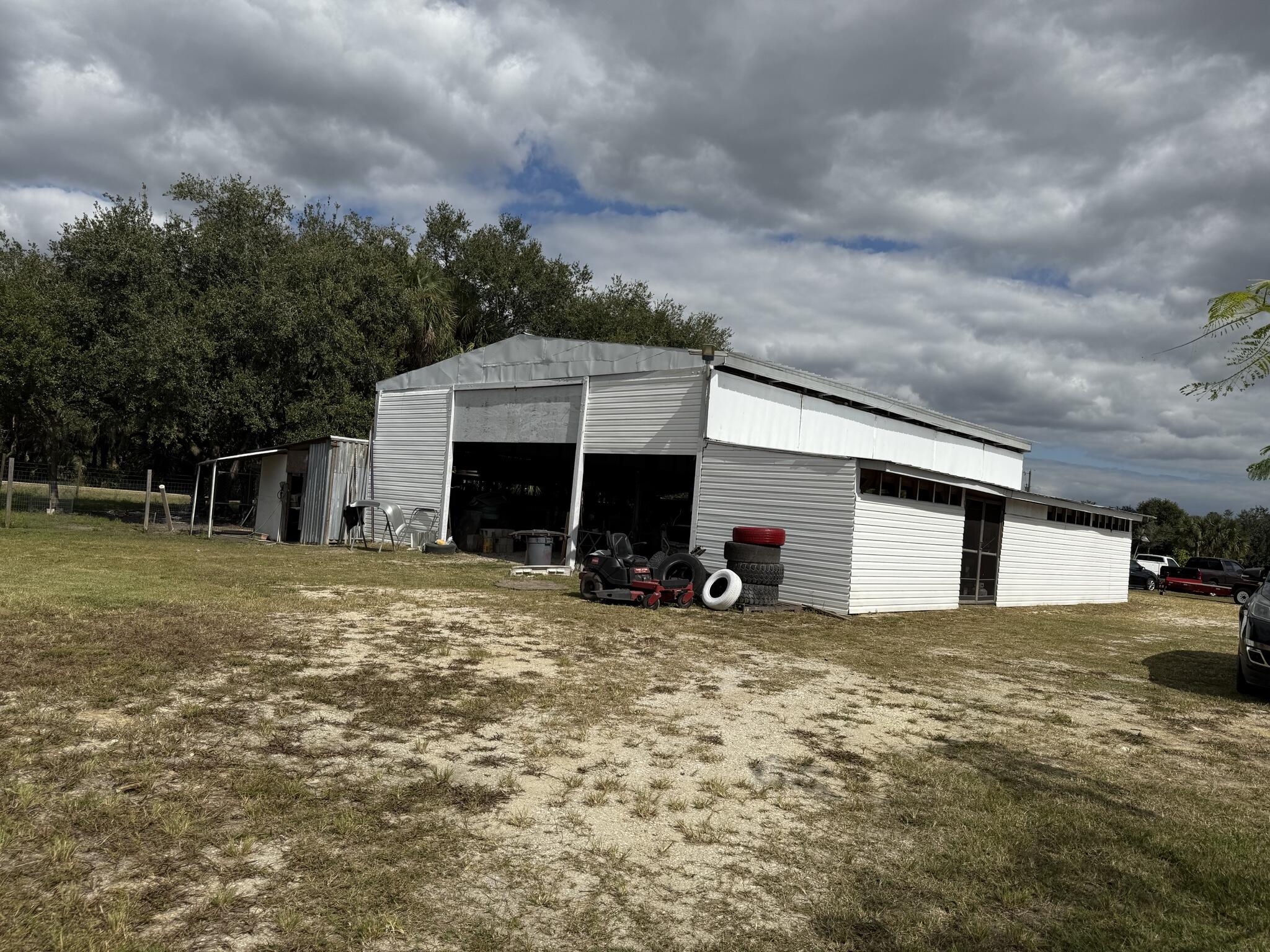 15628 Northwest 310th Street Okeechobee, FL 34972 - Photo 13 of 38 a view of a house with a yard and garage
