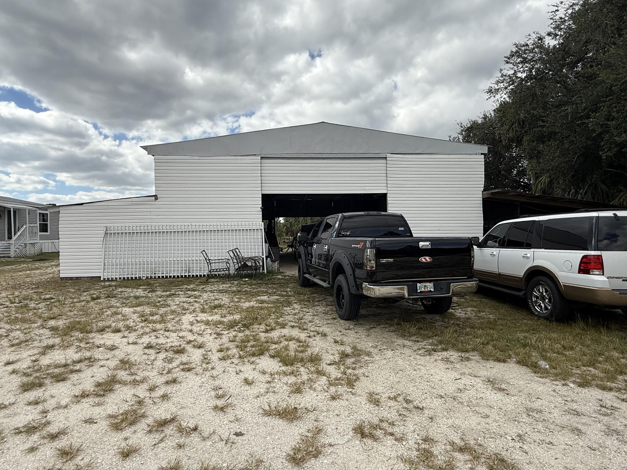 15628 Northwest 310th Street Okeechobee, FL 34972 - Photo 14 of 38 a view of a car in garage