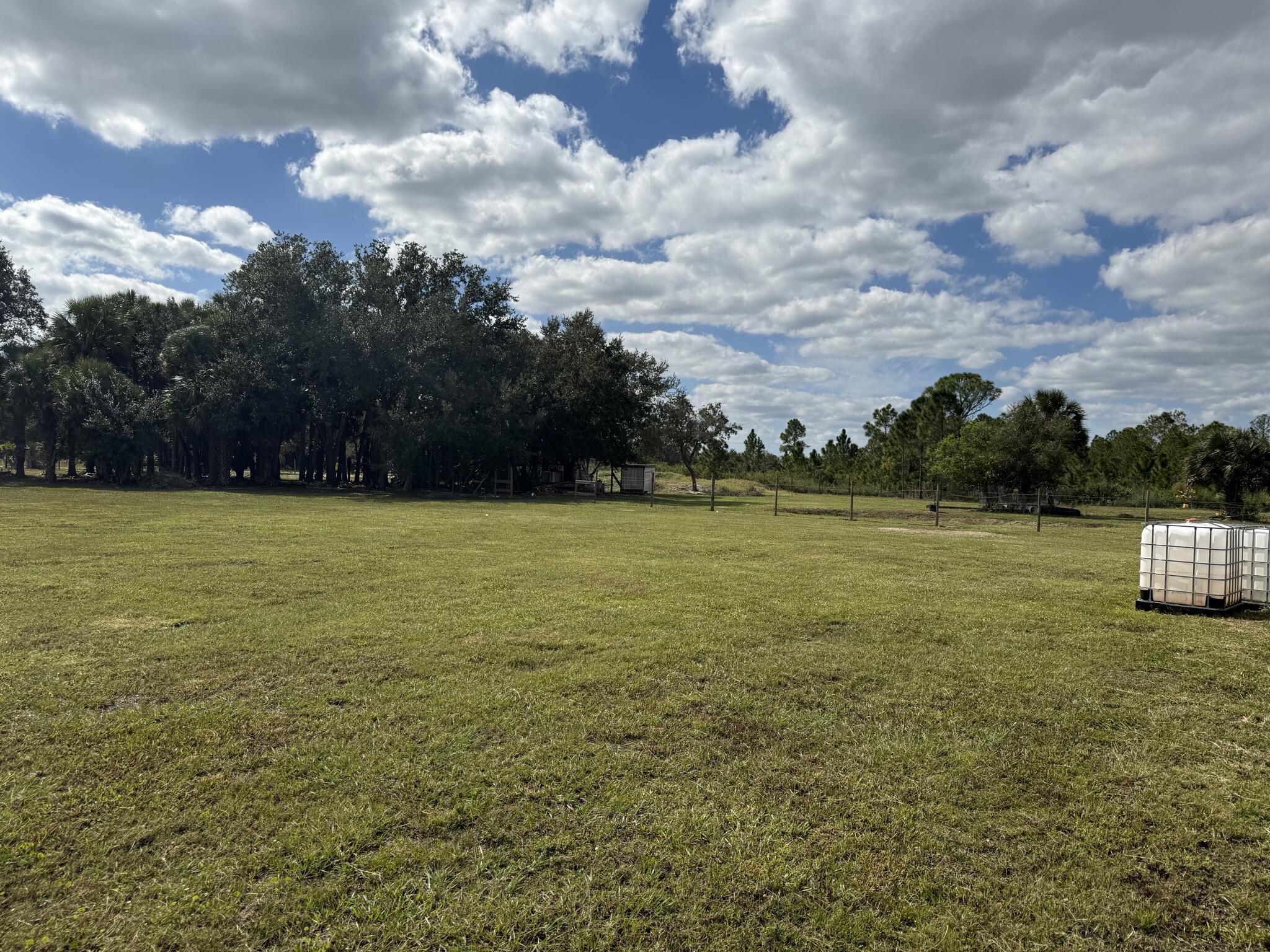 15628 Northwest 310th Street Okeechobee, FL 34972 - Photo 15 of 38 a view of a lake with table and chairs