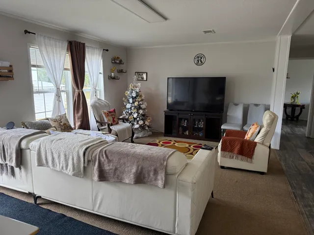 a spacious bedroom with a bed and a flat screen tv