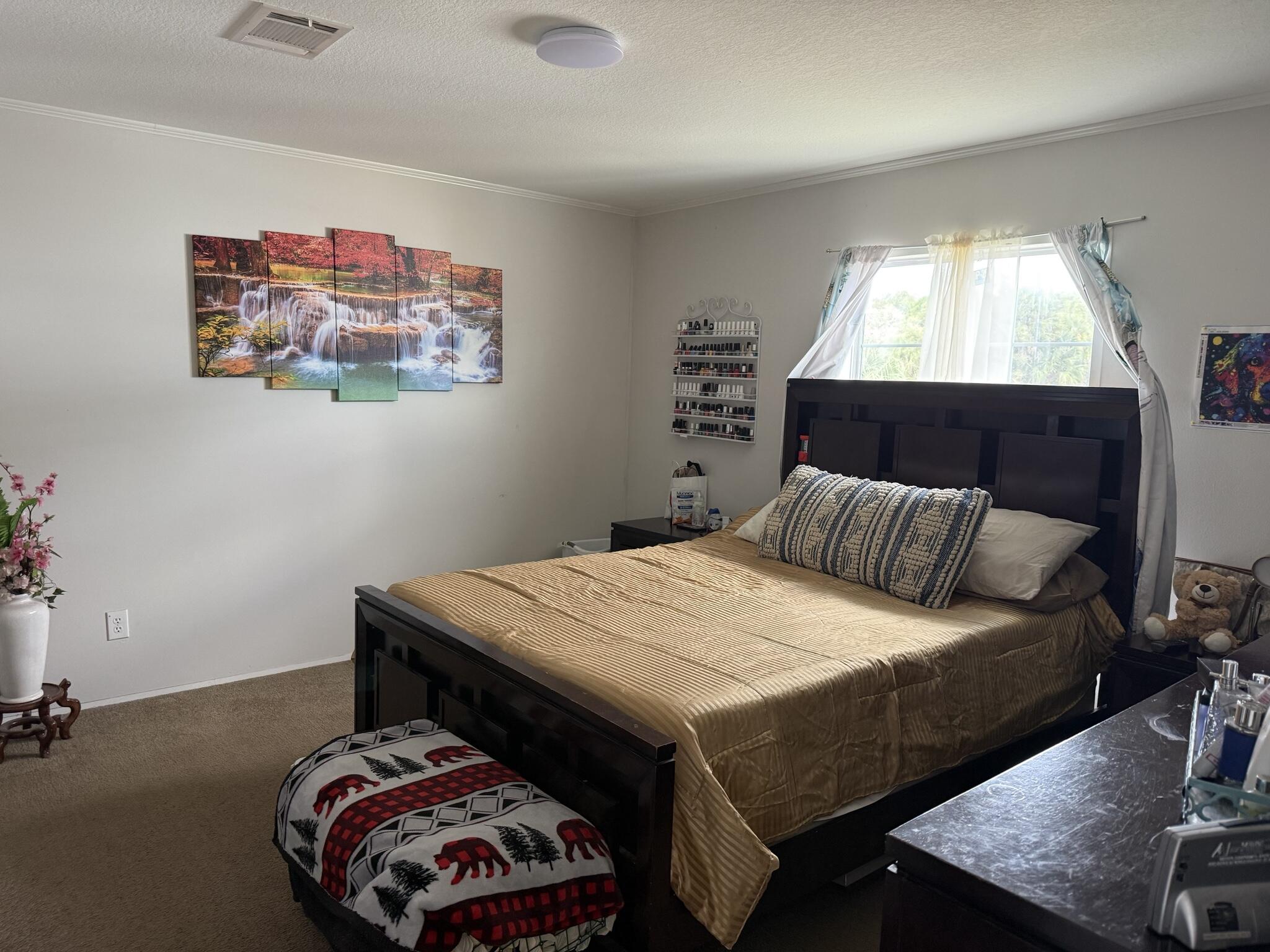 15628 Northwest 310th Street Okeechobee, FL 34972 - Photo 5 of 38 a bedroom with a bed and a table