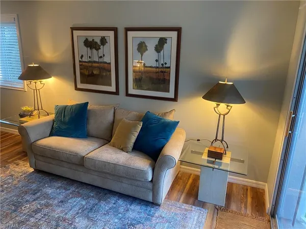 a living room with furniture and a lamp