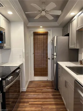a kitchen with stainless steel appliances granite countertop a refrigerator and a sink