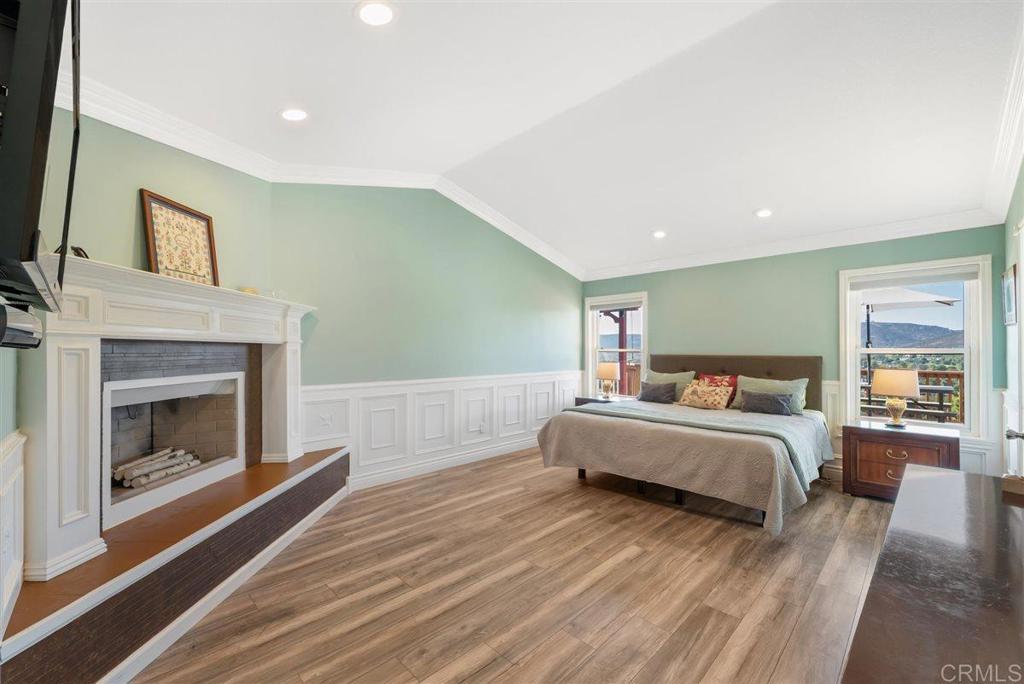 16416 Wikiup Road Ramona, CA 92065 - Photo 16 of 26 a spacious bedroom with a bed and a fireplace