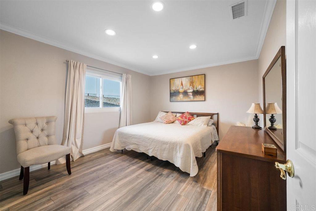 16416 Wikiup Road Ramona, CA 92065 - Photo 21 of 26 a bedroom with a large bed and a couch