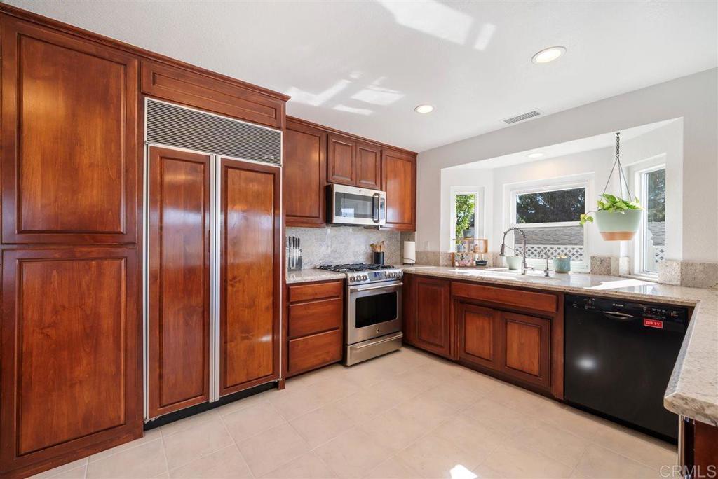 16416 Wikiup Road Ramona, CA 92065 - Photo 8 of 26 a kitchen with stainless steel appliances granite countertop a refrigerator and a sink