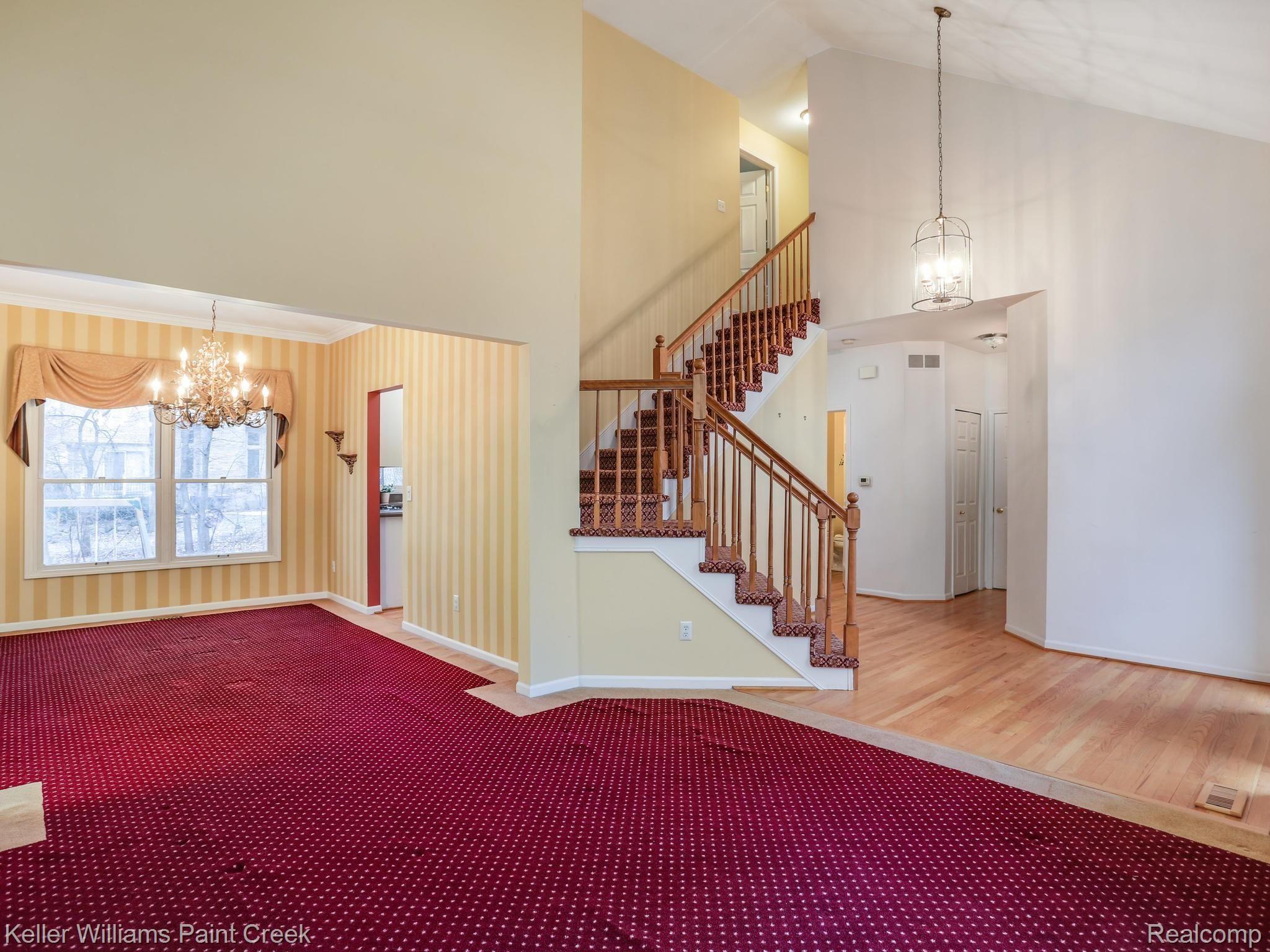 the living room, entry and dining room with an open concept creating a fluid architectural flow. 