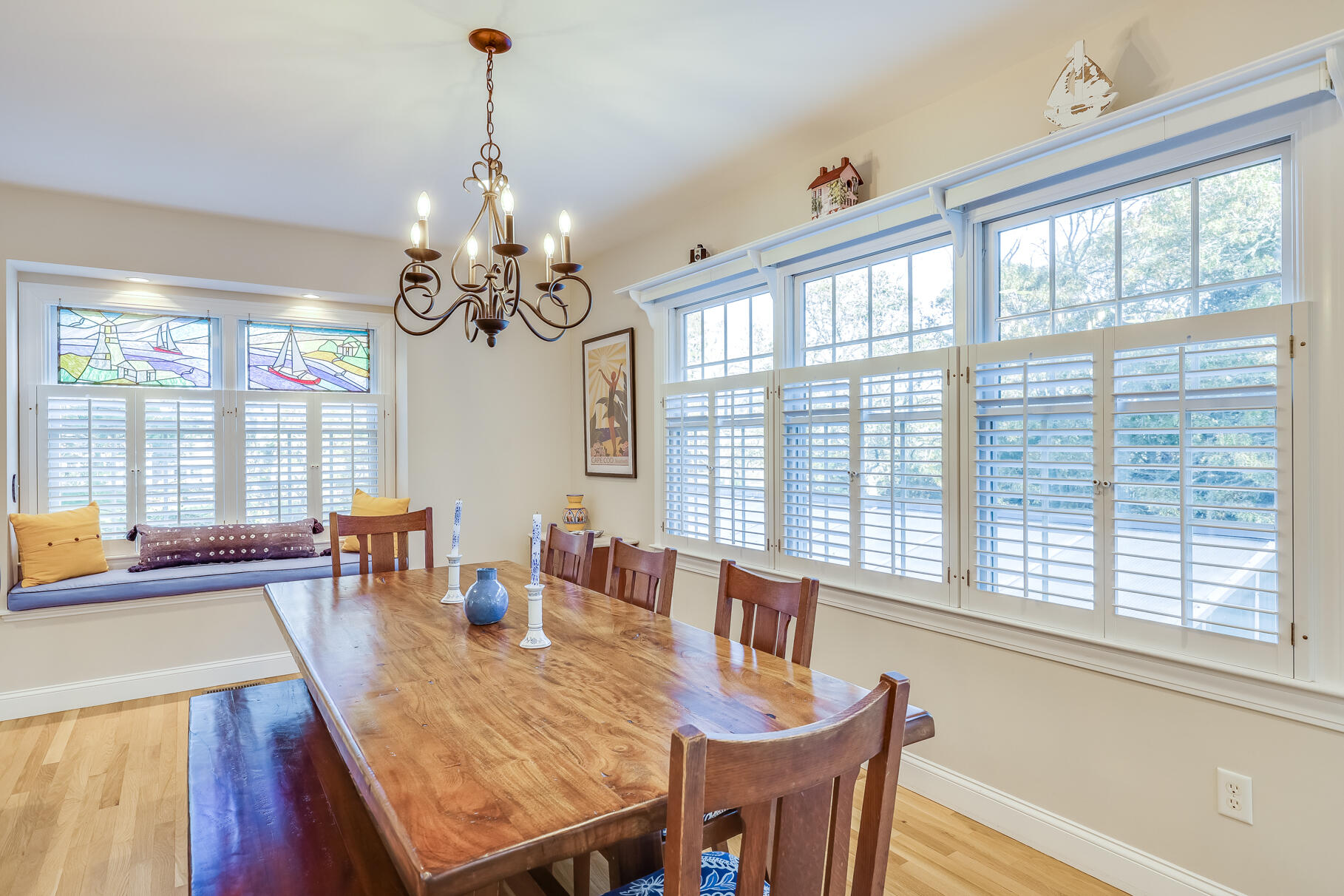 9 Ridgewood Road Orleans, MA 02653 - Photo 21 of 81 a dining room with wooden floor a chandelier a wooden table and chairs