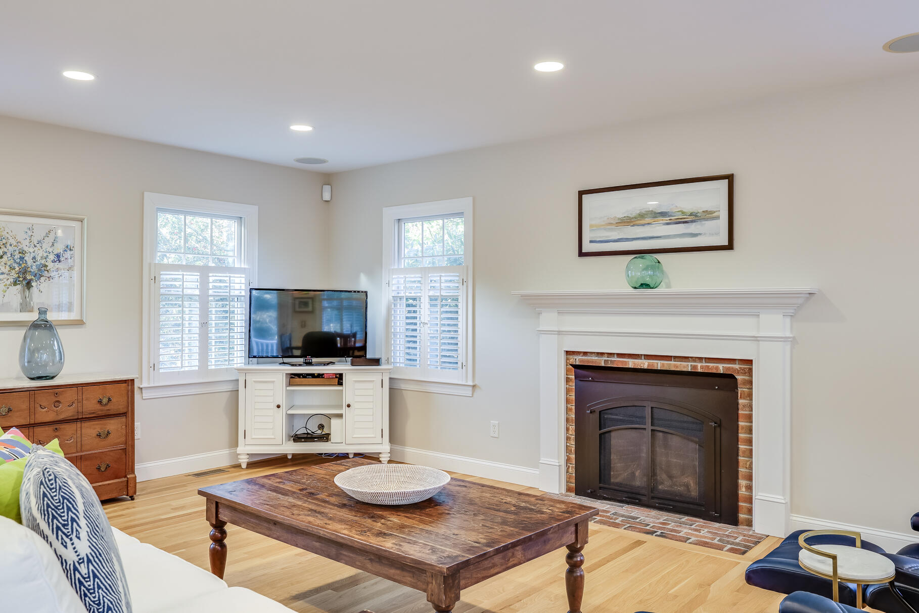 9 Ridgewood Road Orleans, MA 02653 - Photo 22 of 81 a living room with furniture a fireplace and a flat screen tv