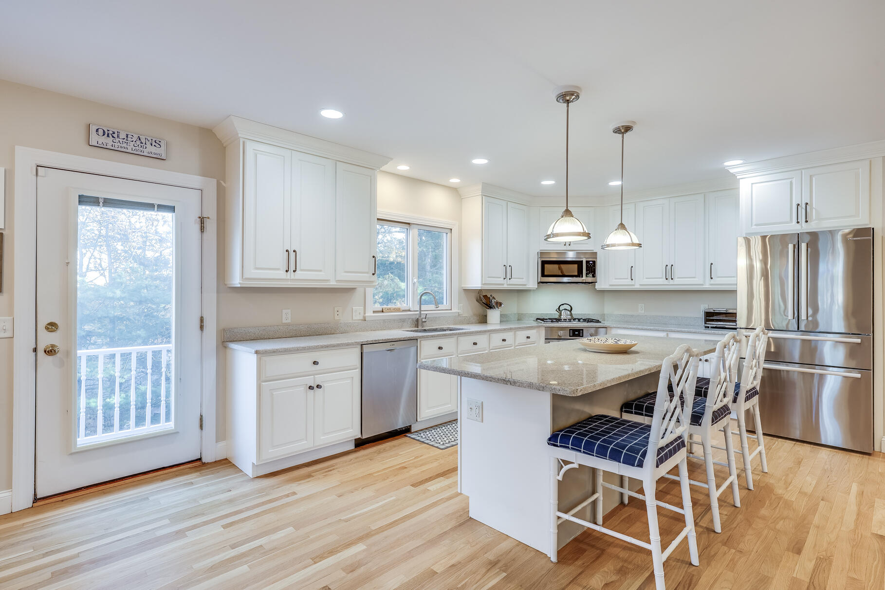 9 Ridgewood Road Orleans, MA 02653 - Photo 23 of 81 a kitchen with stainless steel appliances kitchen island granite countertop a table chairs refrigerator and sink