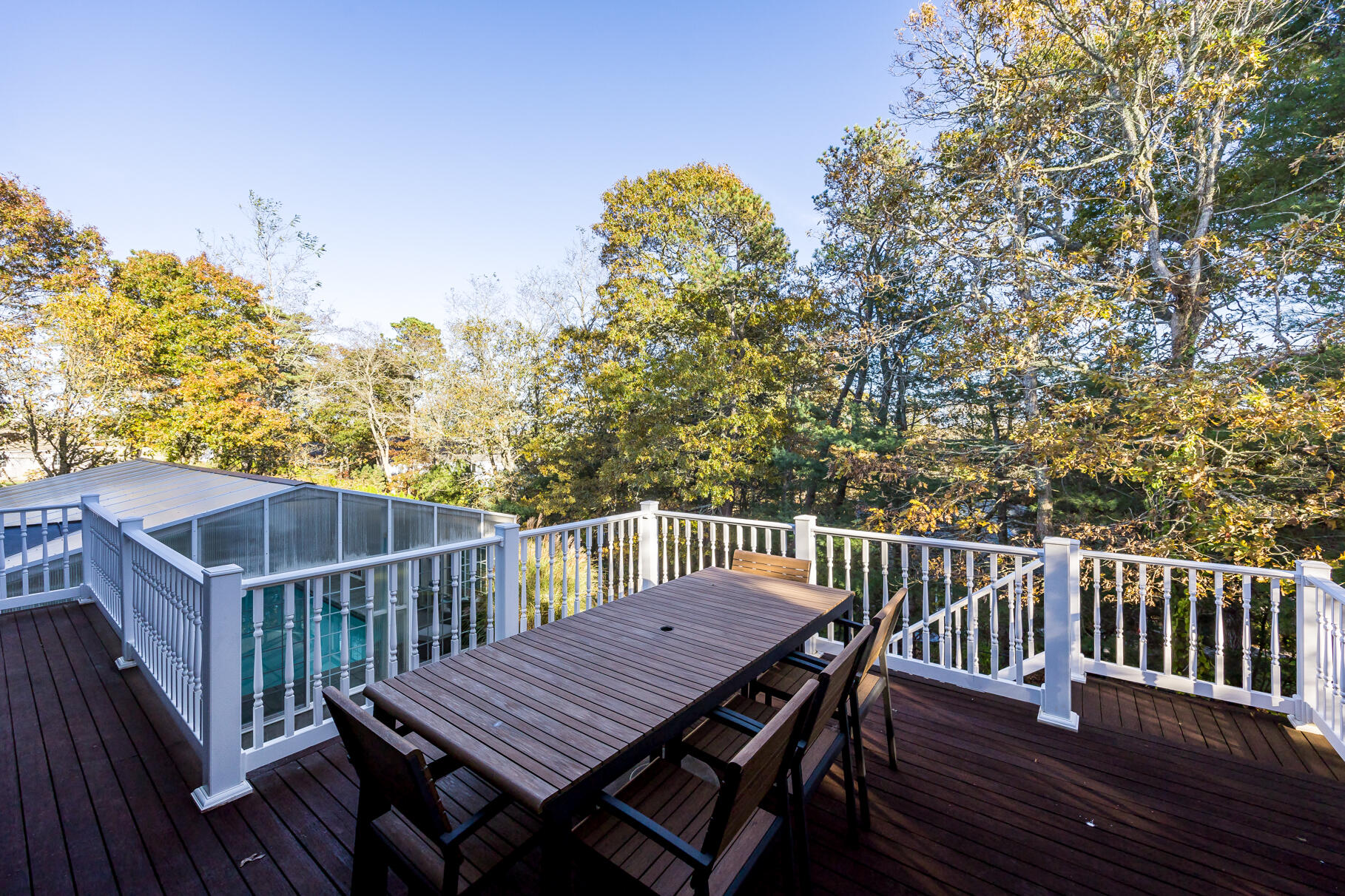 9 Ridgewood Road Orleans, MA 02653 - Photo 79 of 81 a view of a roof deck with table and chairs with wooden floor and fence