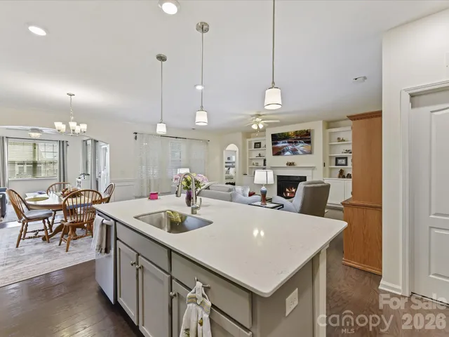 a kitchen with a table chairs and a chandelier