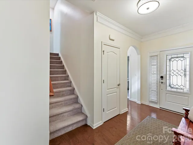 a view of a hallway with entryway wooden floor and front door