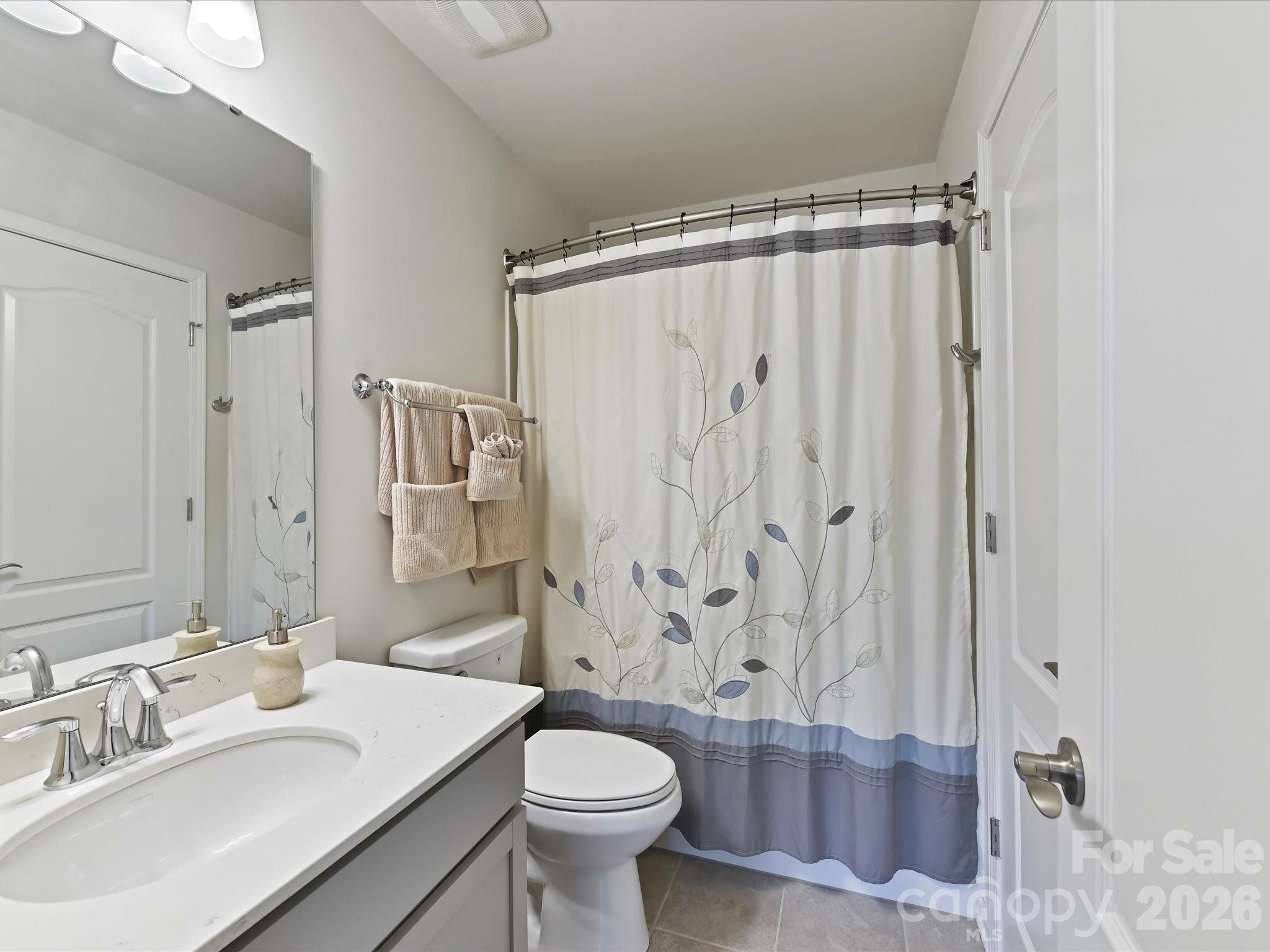 3302 Oliver Stanley Trail Lancaster, SC 29720 - Photo 27 of 48 a bathroom with a shower curtain sink and a toilet