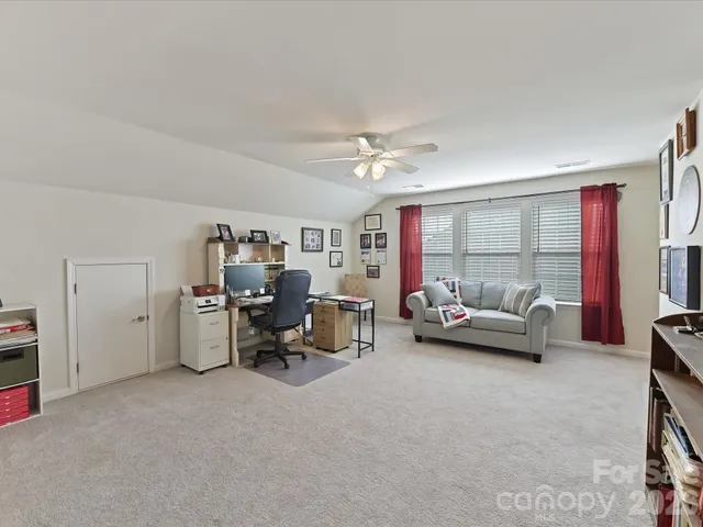 a bedroom with furniture and a large window