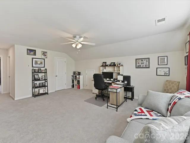 a living room with furniture and white walls