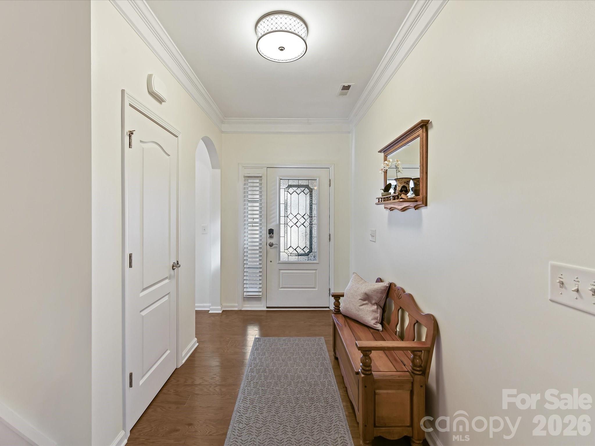 3302 Oliver Stanley Trail Lancaster, SC 29720 - Photo 4 of 48 a hallway with front door wooden floor and cabinet