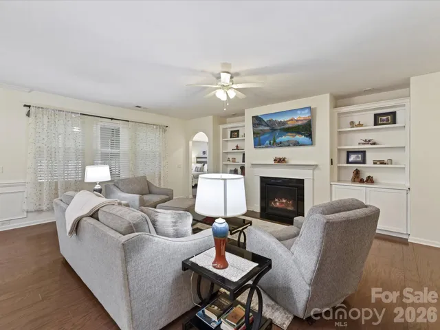 a living room with furniture a fireplace and a table