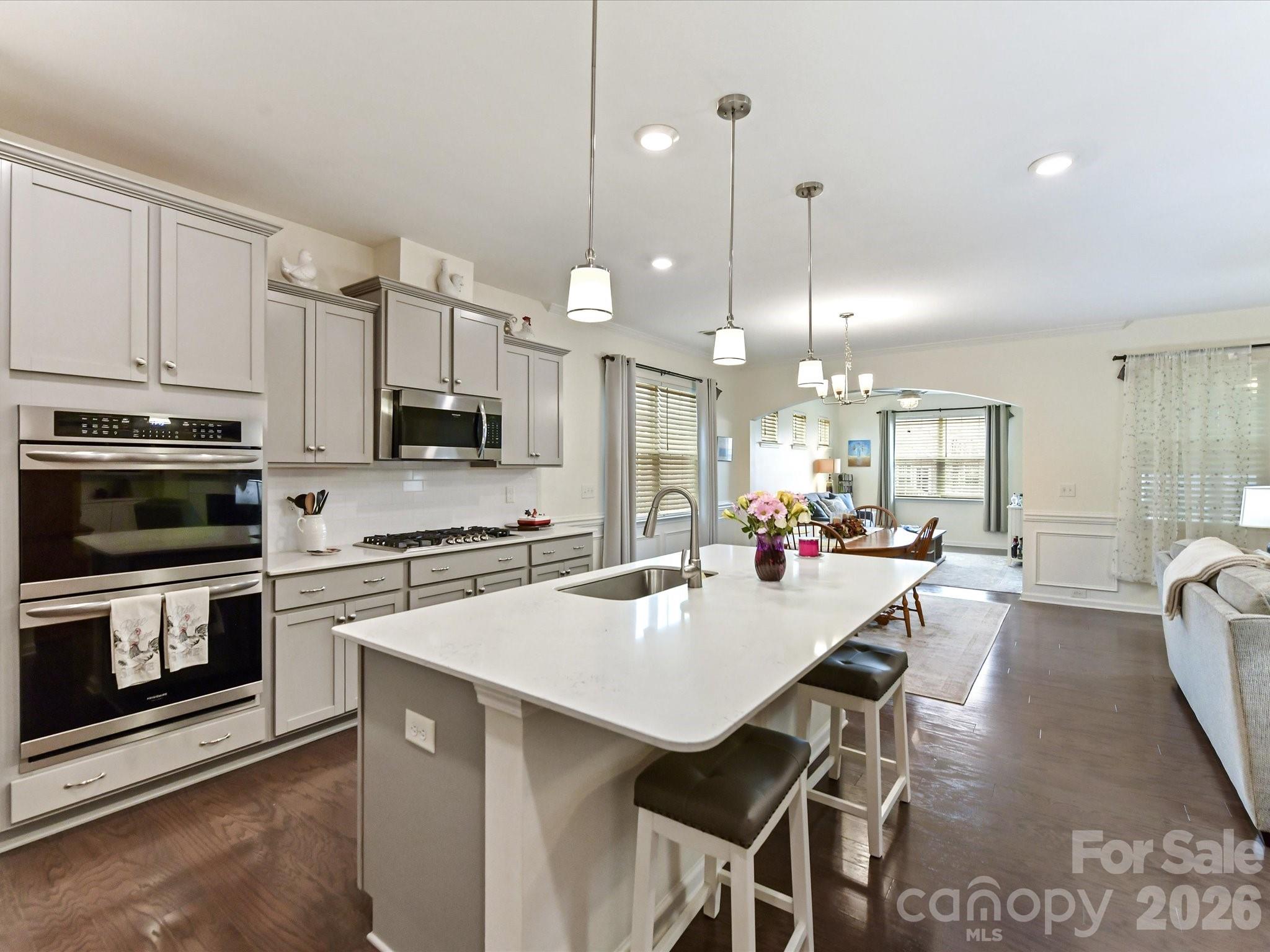 3302 Oliver Stanley Trail Lancaster, SC 29720 - Photo 8 of 48 a kitchen with kitchen island a stove a table and chairs