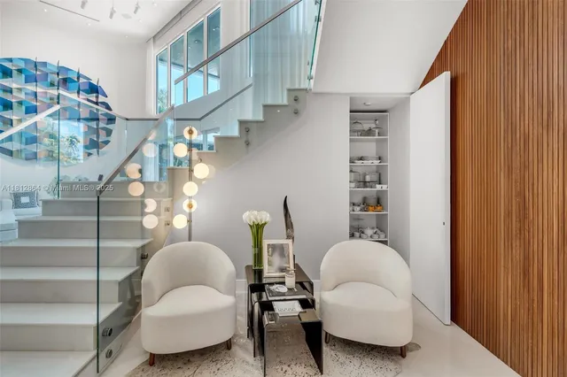 a kitchen with stainless steel appliances kitchen island granite countertop a table chairs sink and cabinets