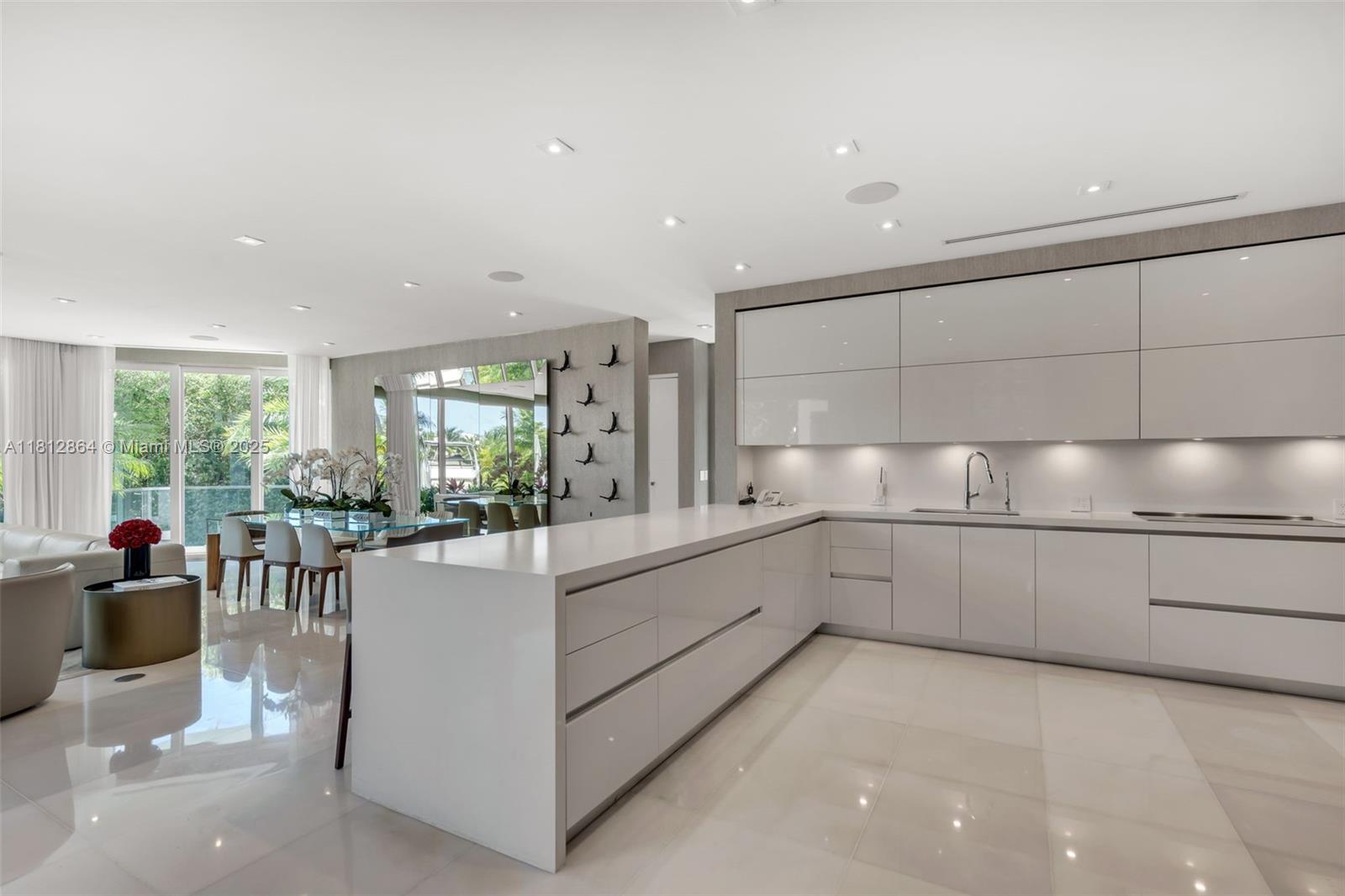 420 Island Drive Key Biscayne, FL 33149 - Photo 15 of 84 a large white kitchen with granite countertop lots of white cabinets