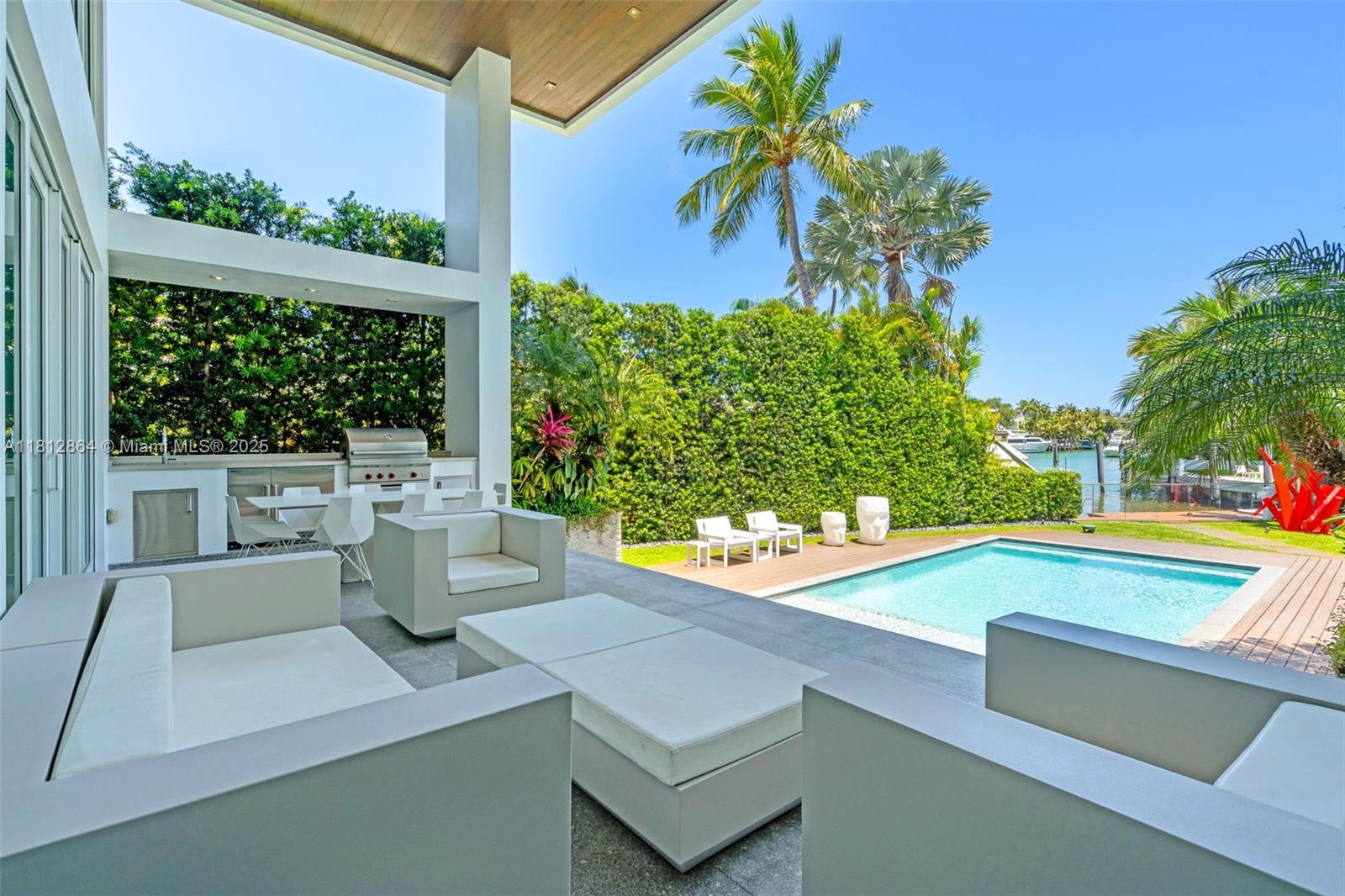 420 Island Drive Key Biscayne, FL 33149 - Photo 56 of 84 a view of a patio with table and chairs and potted plants