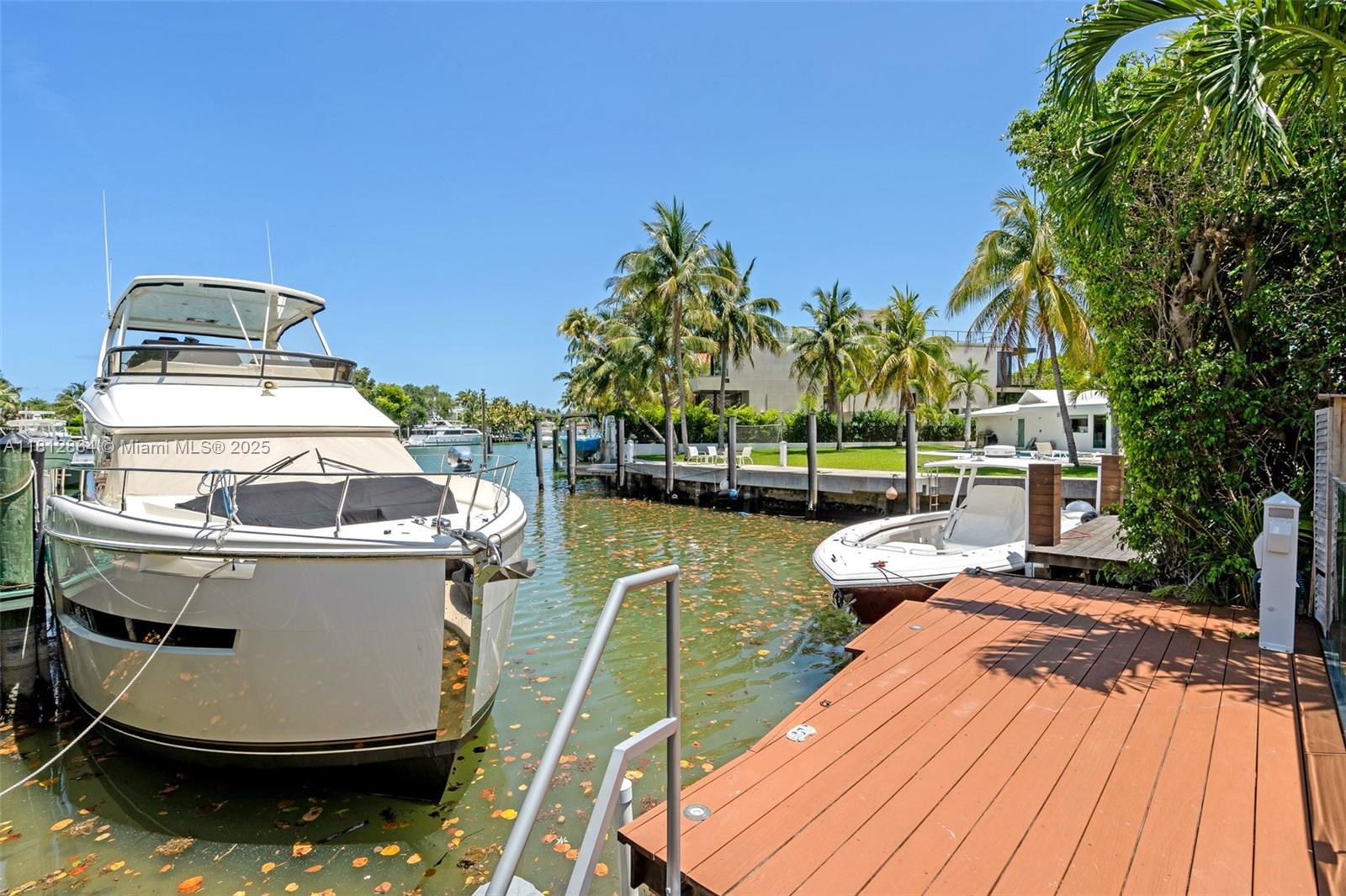 420 Island Drive Key Biscayne, FL 33149 - Photo 57 of 84 a view of a swimming pool with a patio and a yard