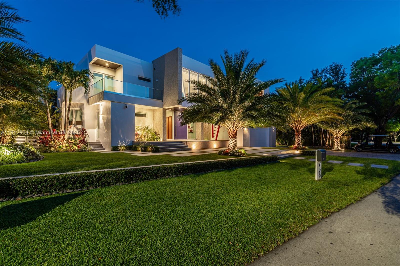 420 Island Drive Key Biscayne, FL 33149 - Photo 60 of 84 a front view of a house with a garden and trees