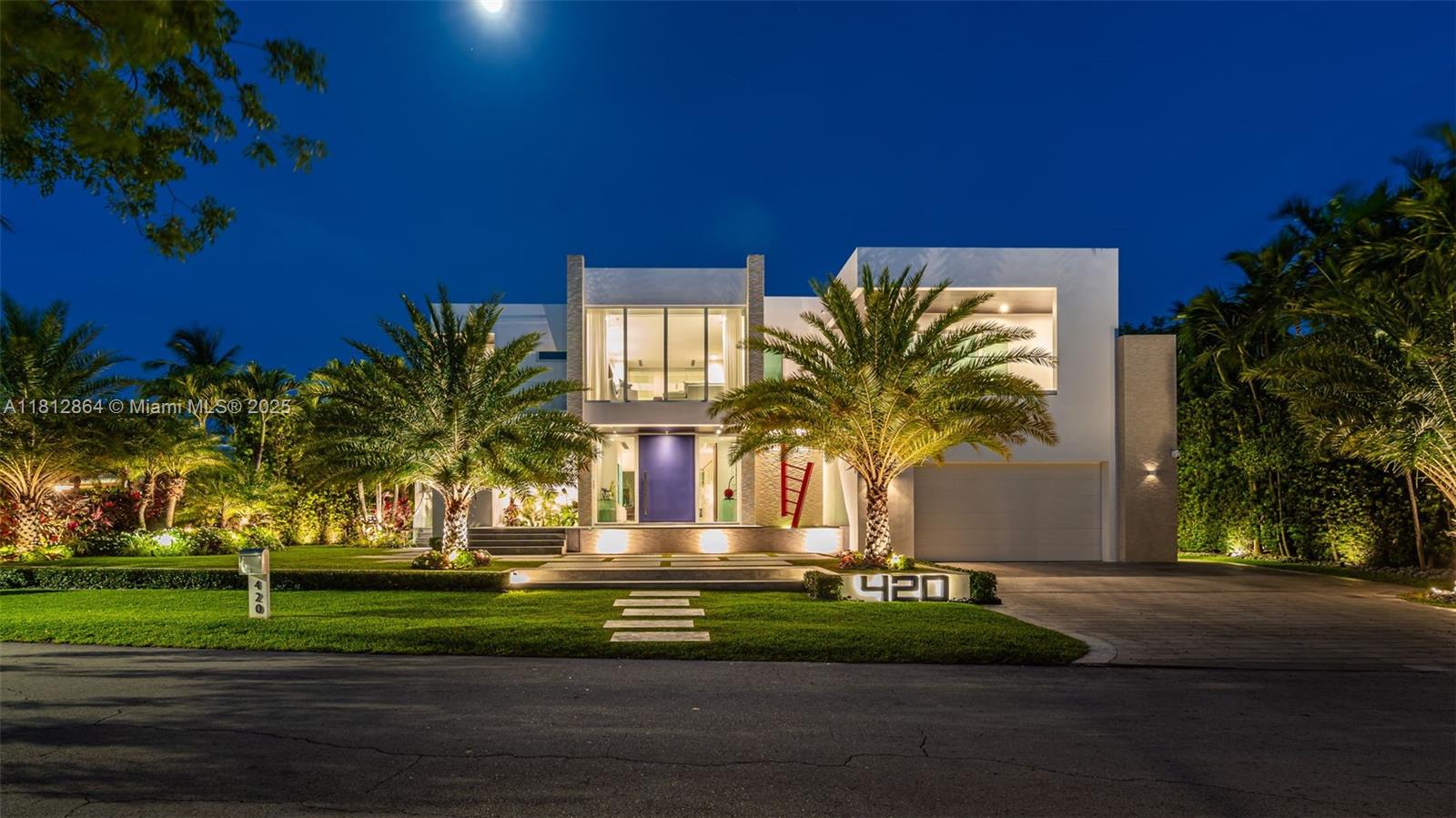 420 Island Drive Key Biscayne, FL 33149 - Photo 63 of 84 a front view of a house with a garden and trees