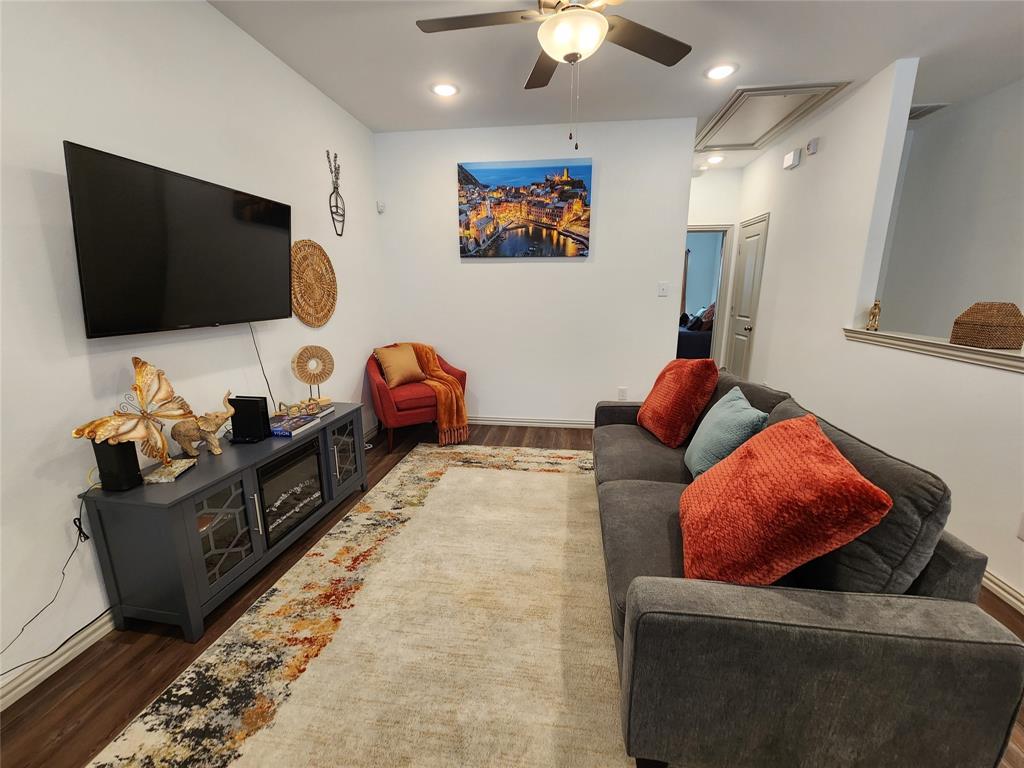 4704 Haltom Road Haltom City, TX 76117 - Photo 11 of 28 a living room with furniture and a flat screen tv