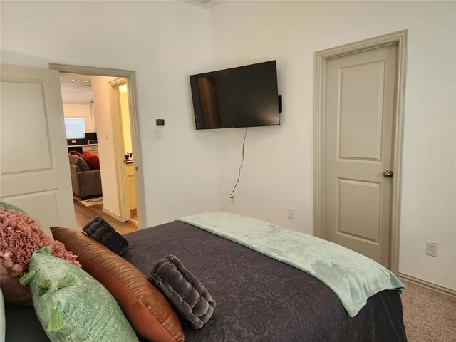 a bedroom with a bed and large windows
