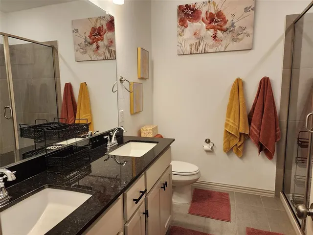 a bed sitting in a bedroom next to a window and a chair