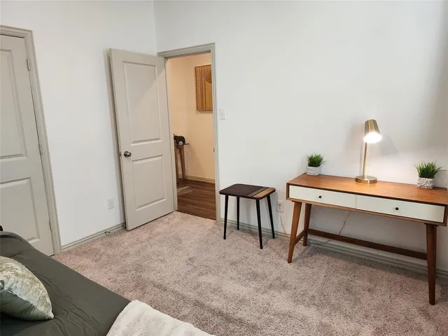 a bedroom with a bed lamp and a window