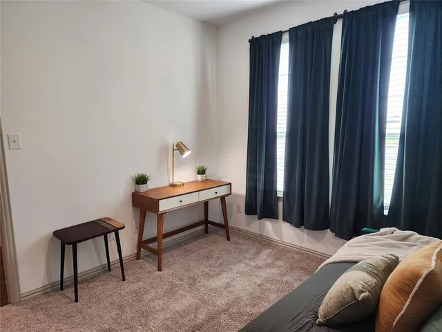 a bedroom with furniture and a lamp