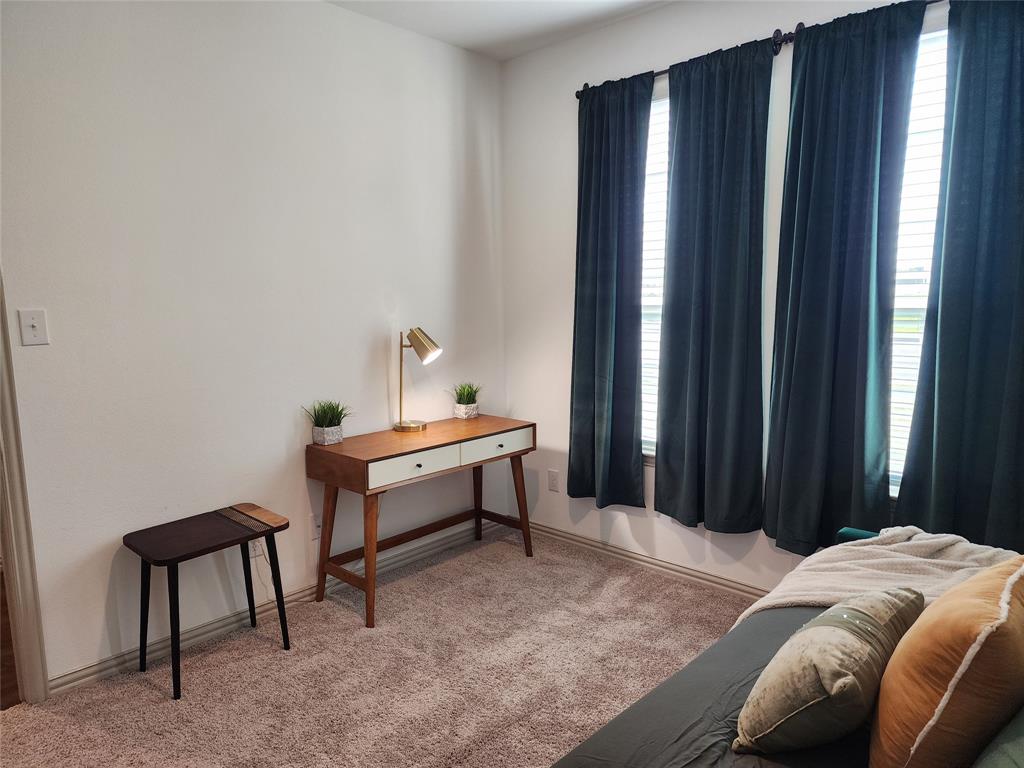 4704 Haltom Road Haltom City, TX 76117 - Photo 21 of 28 a bedroom with a bed and a furniture