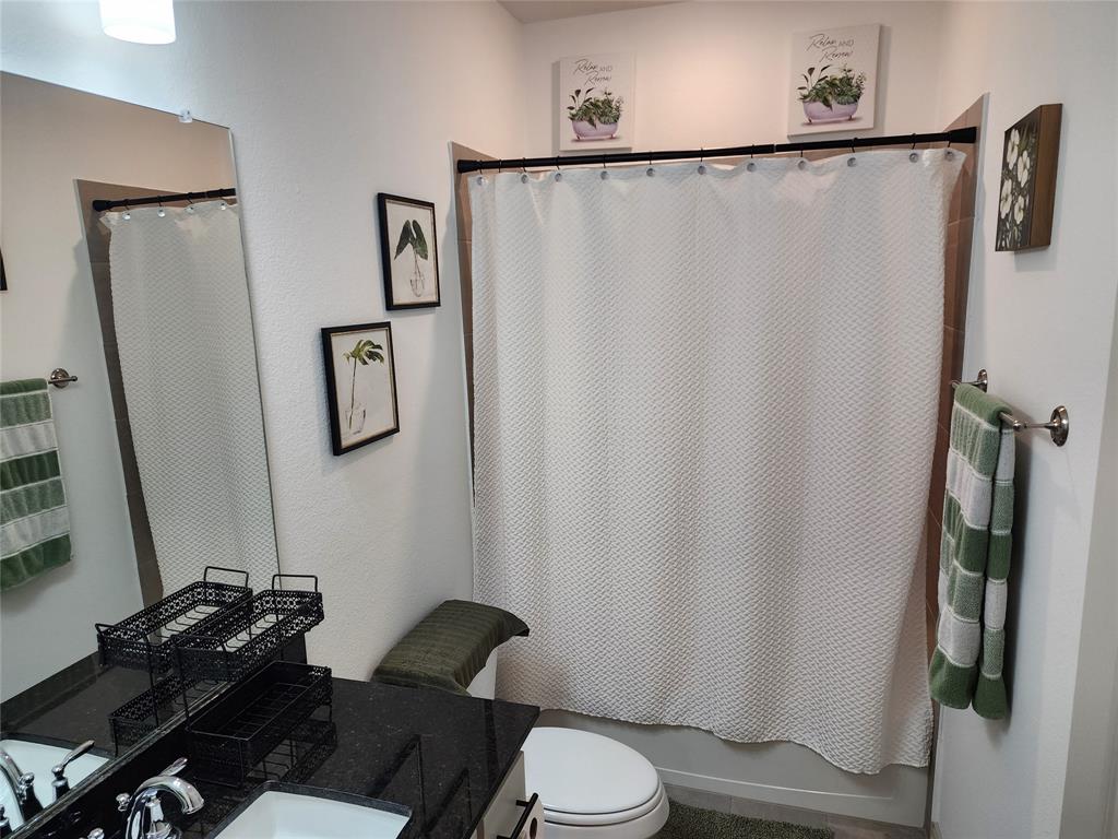 4704 Haltom Road Haltom City, TX 76117 - Photo 23 of 28 a bathroom with a shower and a toilet