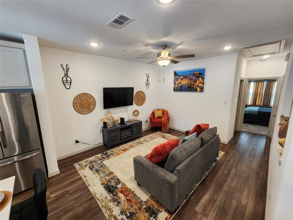 4704 Haltom Road Haltom City, TX 76117 - Photo 7 of 28 a living room with furniture and a flat screen tv