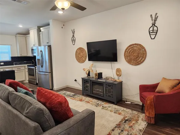 a living room with furniture and a flat screen tv