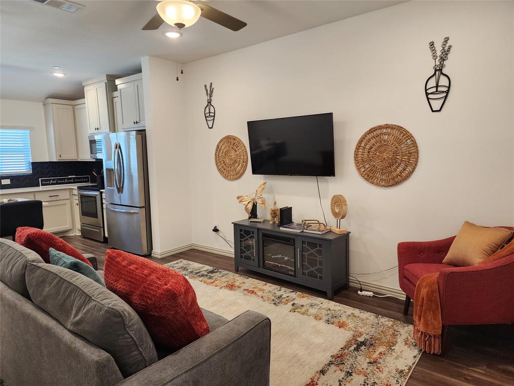 4704 Haltom Road Haltom City, TX 76117 - Photo 8 of 28 a living room with furniture and a flat screen tv