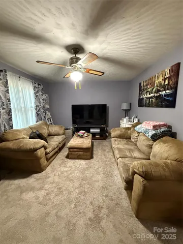 a living room with furniture a chandelier and couch
