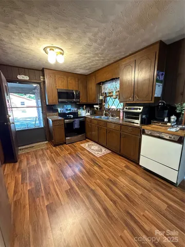 a view of a house with two chairs in a patio