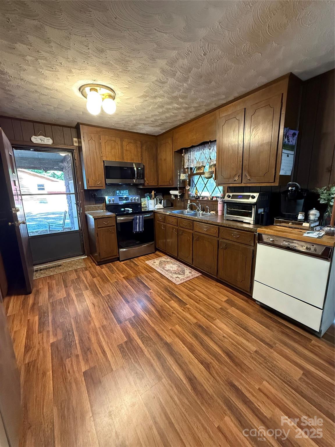 115 Nathaniel Lane Kannapolis, NC 28081 - Photo 15 of 19 a large kitchen with kitchen island a large counter space a sink appliances and cabinets