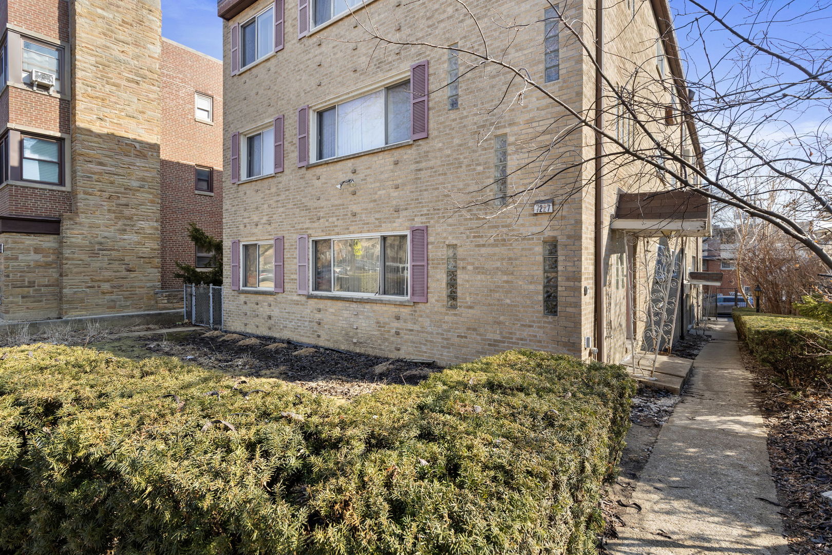 7227 North Ridge Boulevard, Unit 1A Chicago, IL 60645 - Photo 2 of 14 a front view of a house with a yard