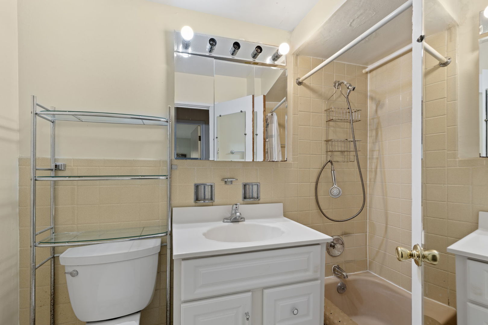 7227 North Ridge Boulevard, Unit 1A Chicago, IL 60645 - Photo 10 of 14 a bathroom with a sink a toilet and shower
