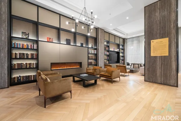 a bedroom with furniture and a book shelf