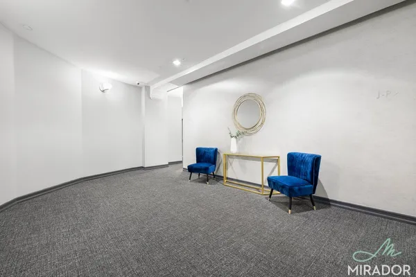 a living room with furniture and a chair