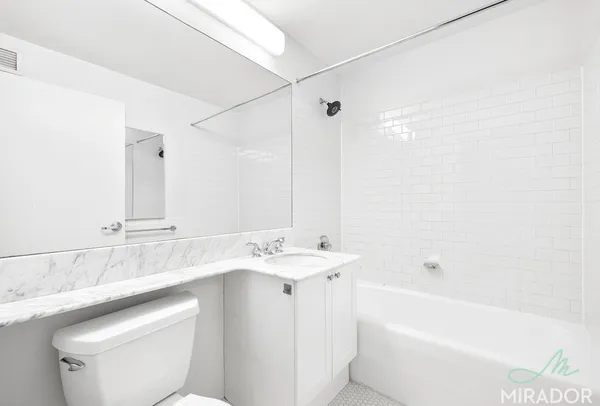 a bathroom with a sink a toilet and a bathtub