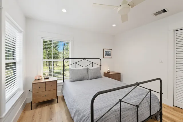 a balcony with wooden floor and trees in the back