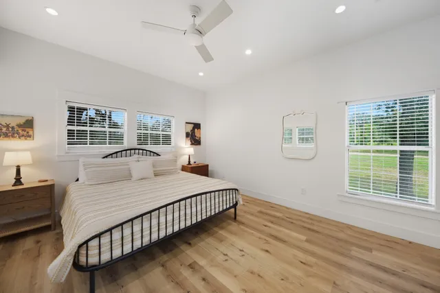 a en suite bathroom with a granite countertop toilet sink and a mirror